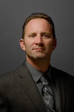 head shot re size eye moved vignette.webp