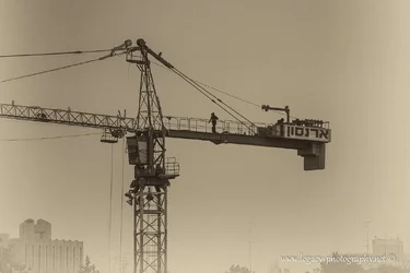 $Man walking on crane in mist BW.webp