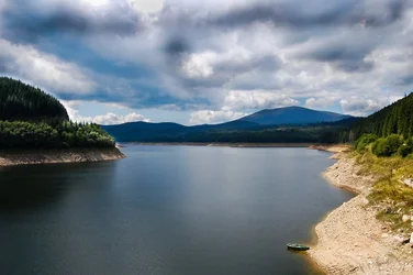 $lake in the mountains and a boat.webp