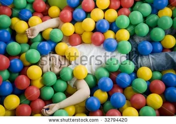 $stock-photo-happy-girl-playing-in-colorful-balls-32794420.webp