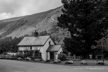 $House in Glendalough against mountan backdrop - BW - selective color.webp