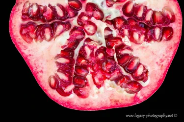 $Pomegranate half on black - cut off.webp