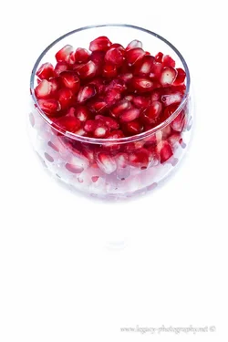 $Pomegranate seeds in wine glass - flash from bottom.webp