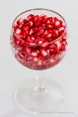 $Pomegranate seeds in wine glass.webp