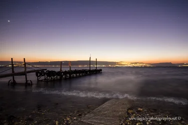 $Kinneret at sunset with pier at Ein Gev.webp