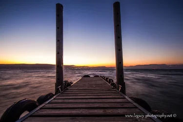 $Pier leading into the Kinneret  and Tiberias at Sunset.webp