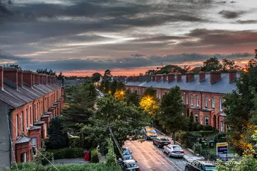 $Irish Sun Setting over row homes.webp
