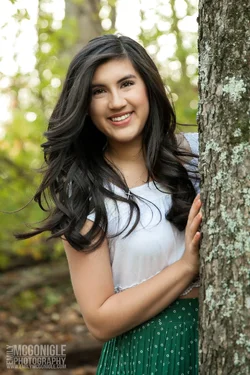 $senior-portrait-tree-woods-smiling.webp