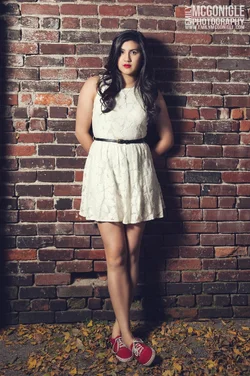 $brick-wall-dress-senior-portrait.webp