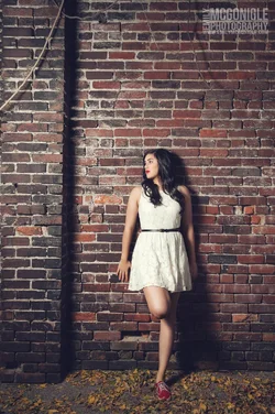 $leaning-brick-wall-dress-fashion.webp