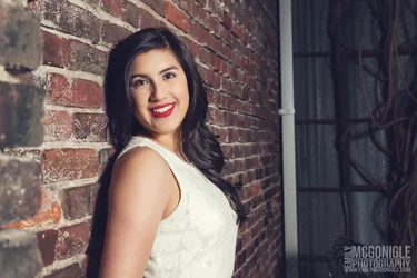 $smiling-headshot-senior-portrait-brick.webp