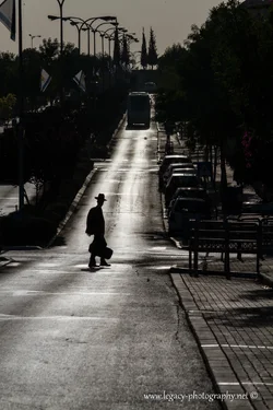 $RBS Ayalon street in the early morning - boy with hat and case crossing - silhouette.webp