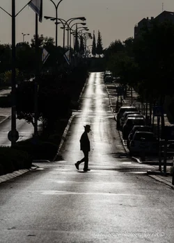 $RBS Ayalon street in the early morning - boy with hat crossing - silhouette.webp