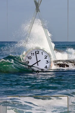 $Disappearing Clock structure over Explosion of water over the rocks - Mediterranean.webp