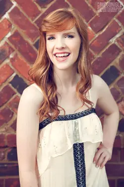 $brick-wall-girl-red-head.webp