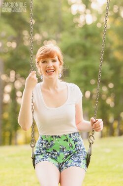 $girl-swinging-smiling-shorts-redhead.jpg