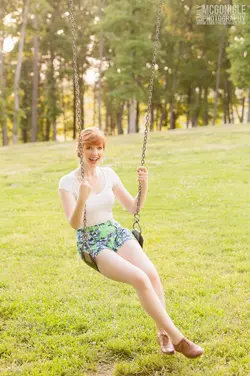 $happy-girl-swing-red-hair.webp