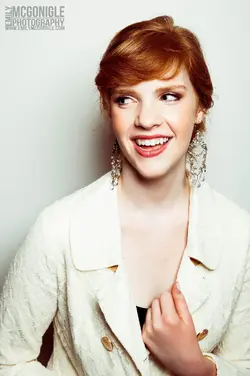 $smiling-redhead-white-background-portrait.webp
