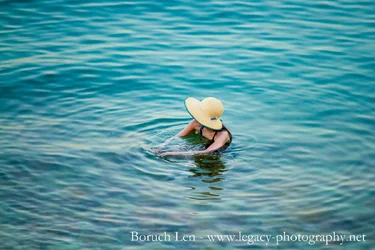 Woman in hat in Dead Sea.webp