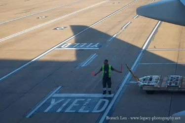 Airline Worker bringing in plane cropped.webp