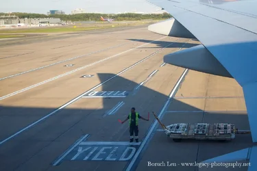 Airline Worker bringing in plane.webp