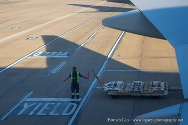 Airline Worker bringing in plane cropped - 2.webp