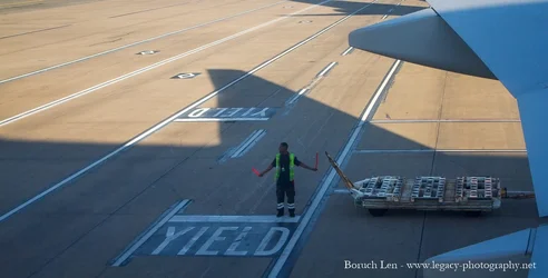 Airline Worker bringing in plane cropped - 3.webp