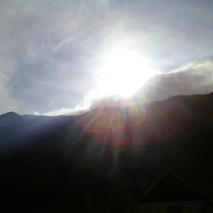 The sun smiles over mountains