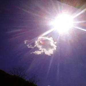 The sun smiles over mountains