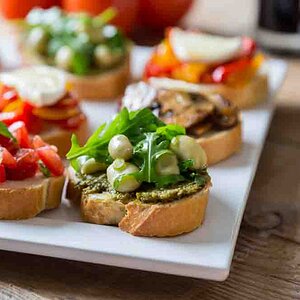 Bruschetta with beans and arugula, mushrooms, goat cheese