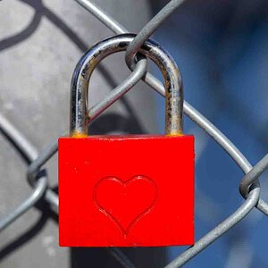 Red heart lock on fence