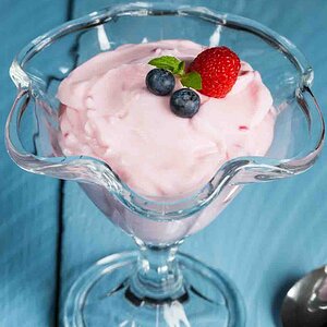 Raspberry cream dessert with mint and fruits
