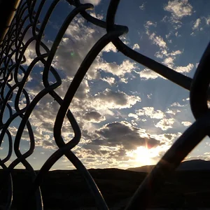Sunset and chain link fence.webp
