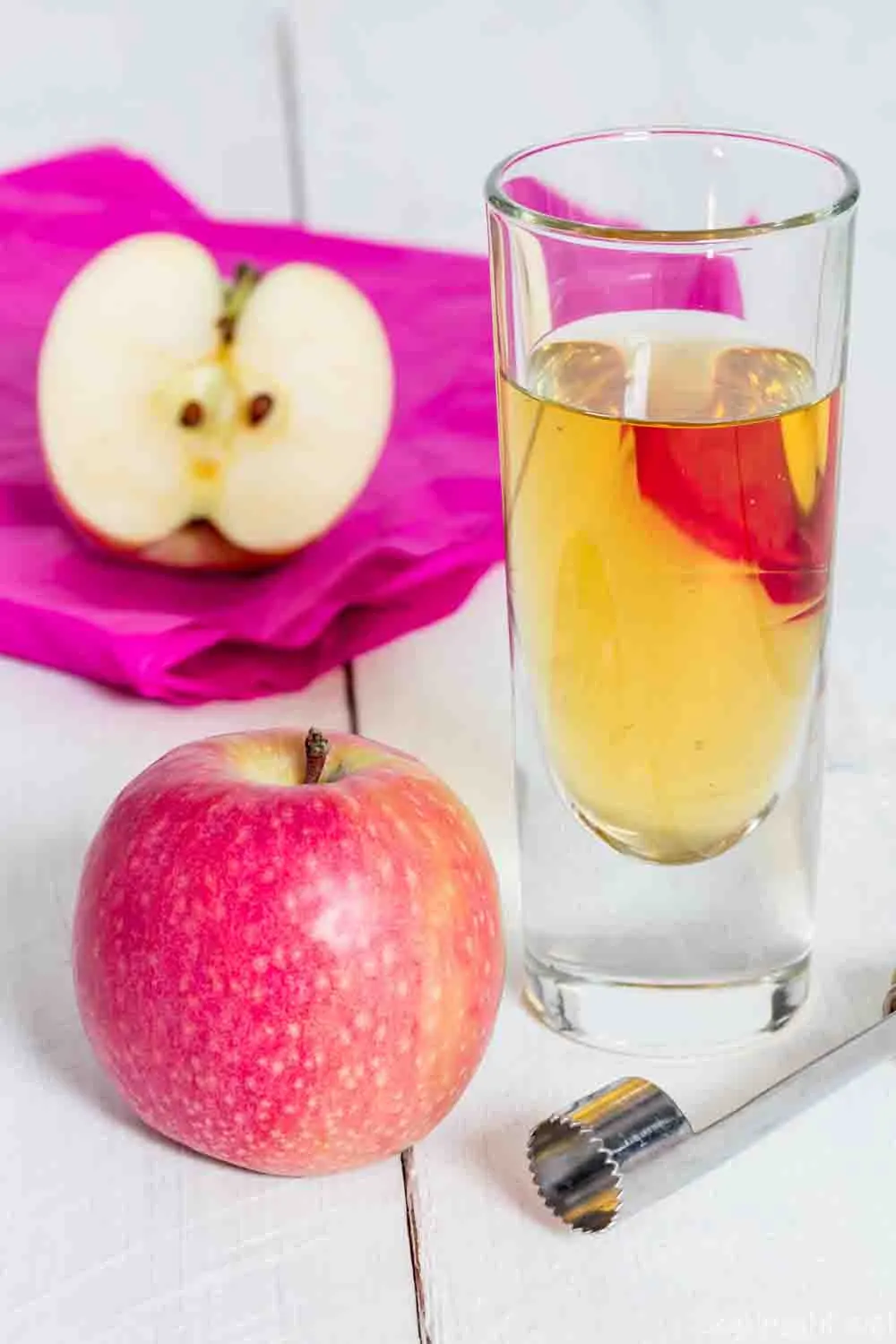 Apple juice freshly squeezed in glass on wood