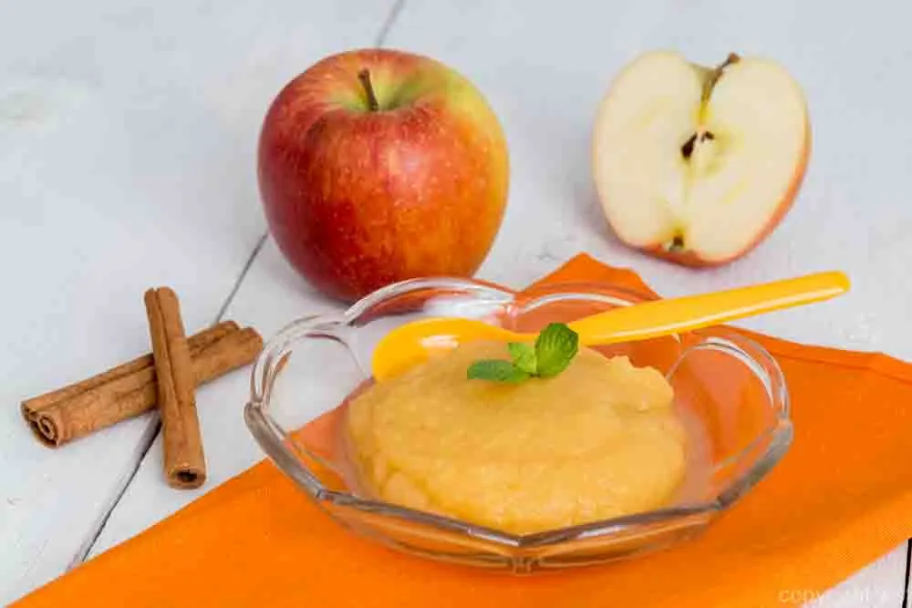 Applesauce with cinnamon and orange spoon