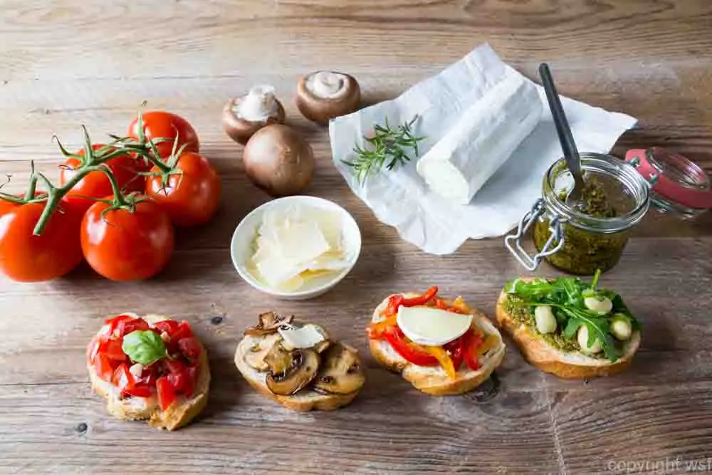 Bruschetta with beans and arugula, mushrooms, goat cheese