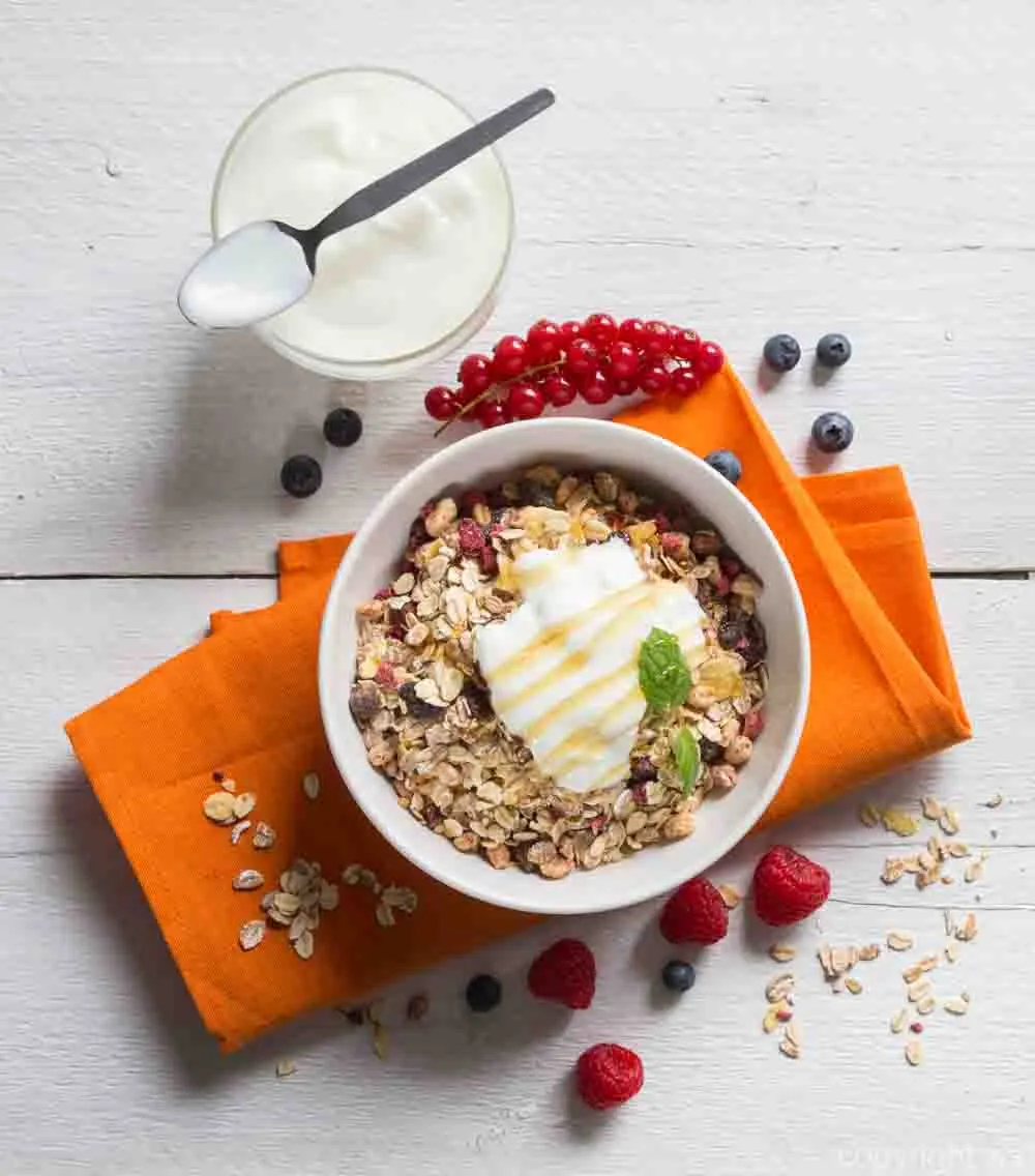Cereal with yogurt and fruits on wood