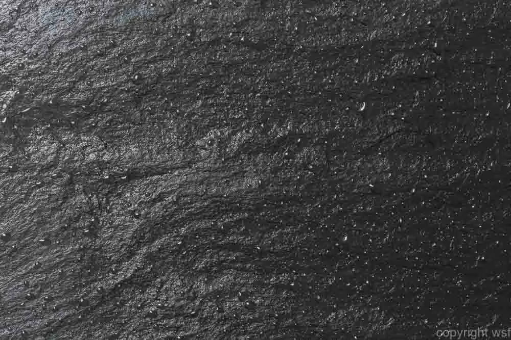 Glossy black slate background or texture