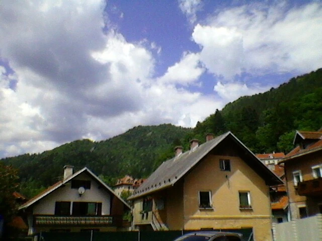Old houses, mountains and clouds