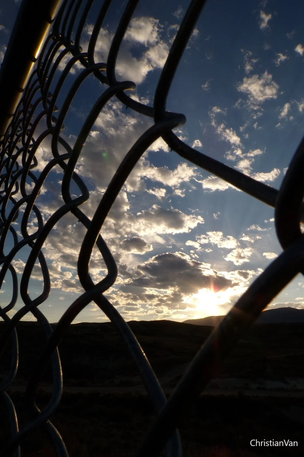 Sunset and chain link fence.webp