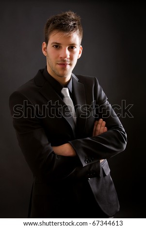 stock-photo-fashion-young-businessman-black-suit-casual-tie-on-black-background-67344613.jpg